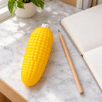 Corn squishy, on a desk with a notebook and pencil