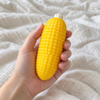 Corn on the cob squishy, held toward the camera, first-person view