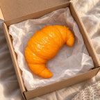Croissant squishy taba, unboxed from a parcel with tissue paper