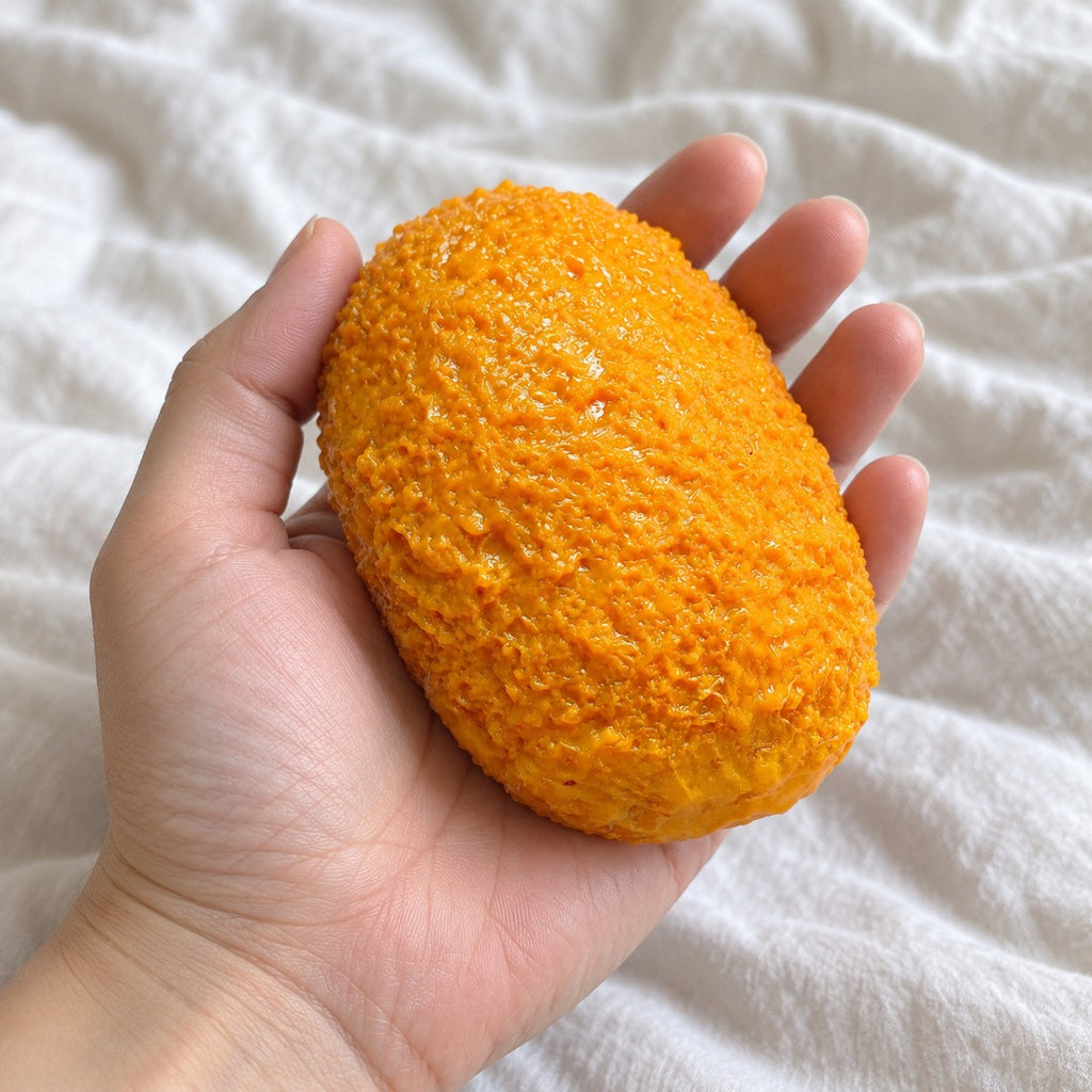 Croquette squishy, held toward the camera, first-person view