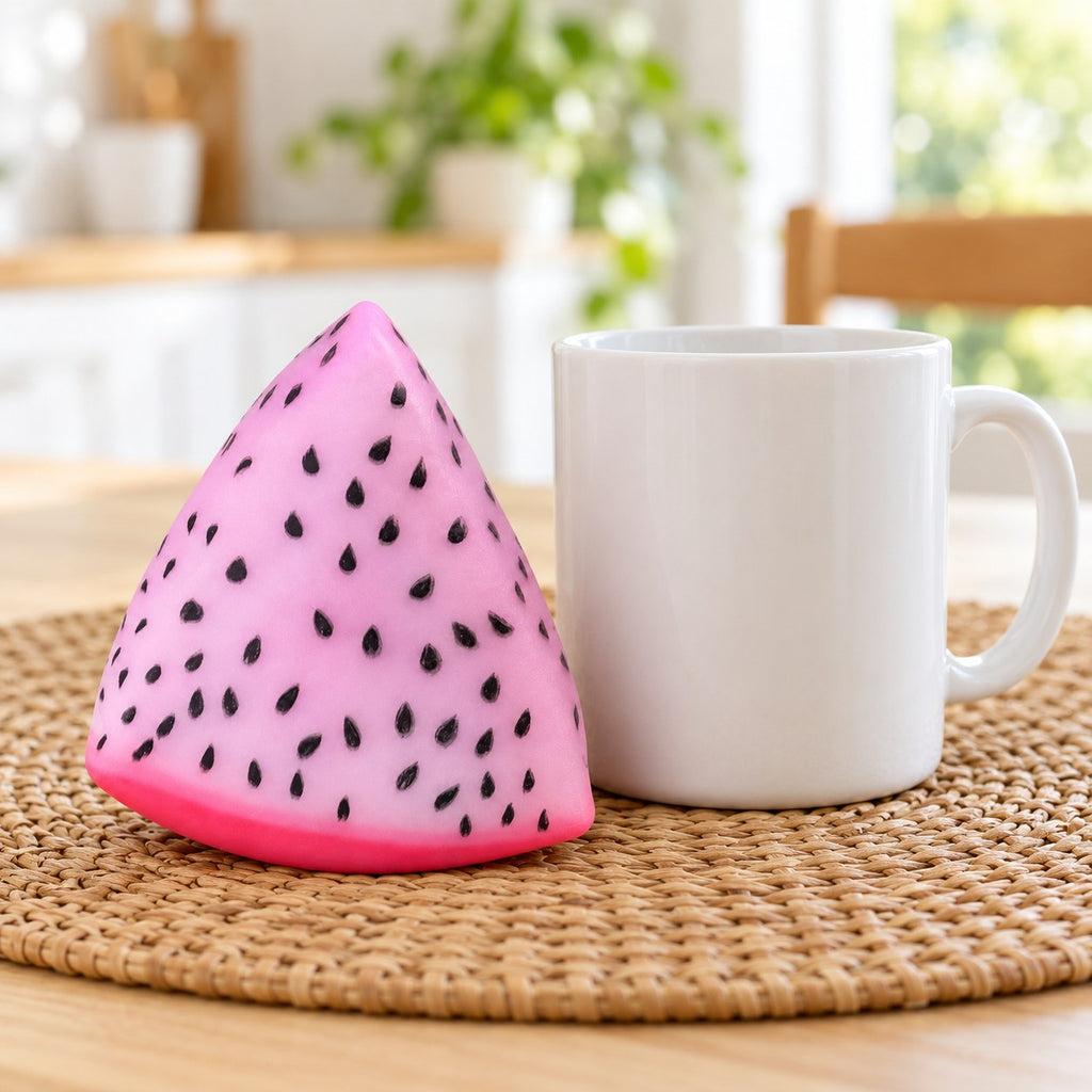 Crunchy Dragon Fruit Squishy, Changes Color in Sunlight, next to a coffee mug for size comparison