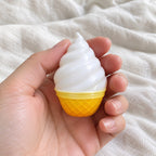 Ice cream squishy mini, held toward the camera, first-person view