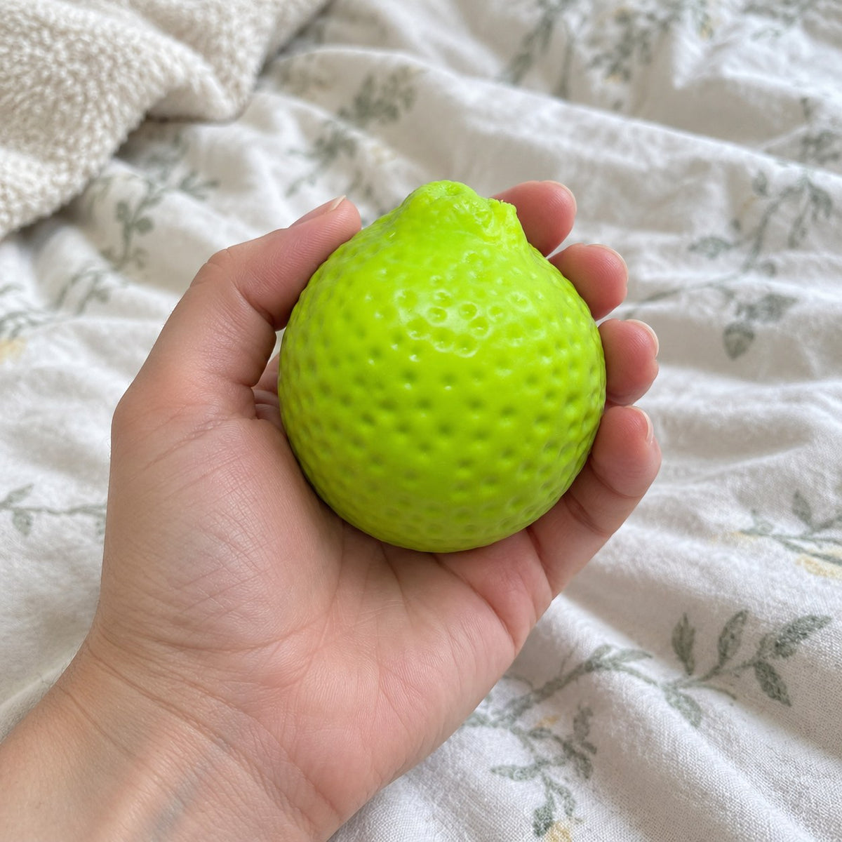 Lemon squishy crunchy, held toward the camera, first-person view
