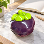 Mangosteen squishy crunchy, on a desk with a notebook and pencil