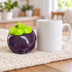 Mangosteen squishy, next to a coffee mug for size comparison