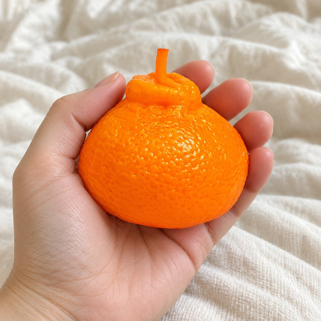Orange squishy, held toward the camera, first-person view