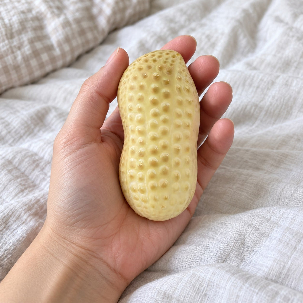 Peanut squishy crunchy, held toward the camera, first-person view