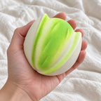 Pistachio squishy, held toward the camera, first-person view