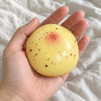 Potato squishy slow rising, held toward the camera, first-person view