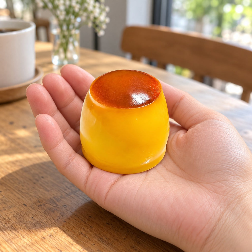 Pudding squishy crunchy, held in a hand to show the real size