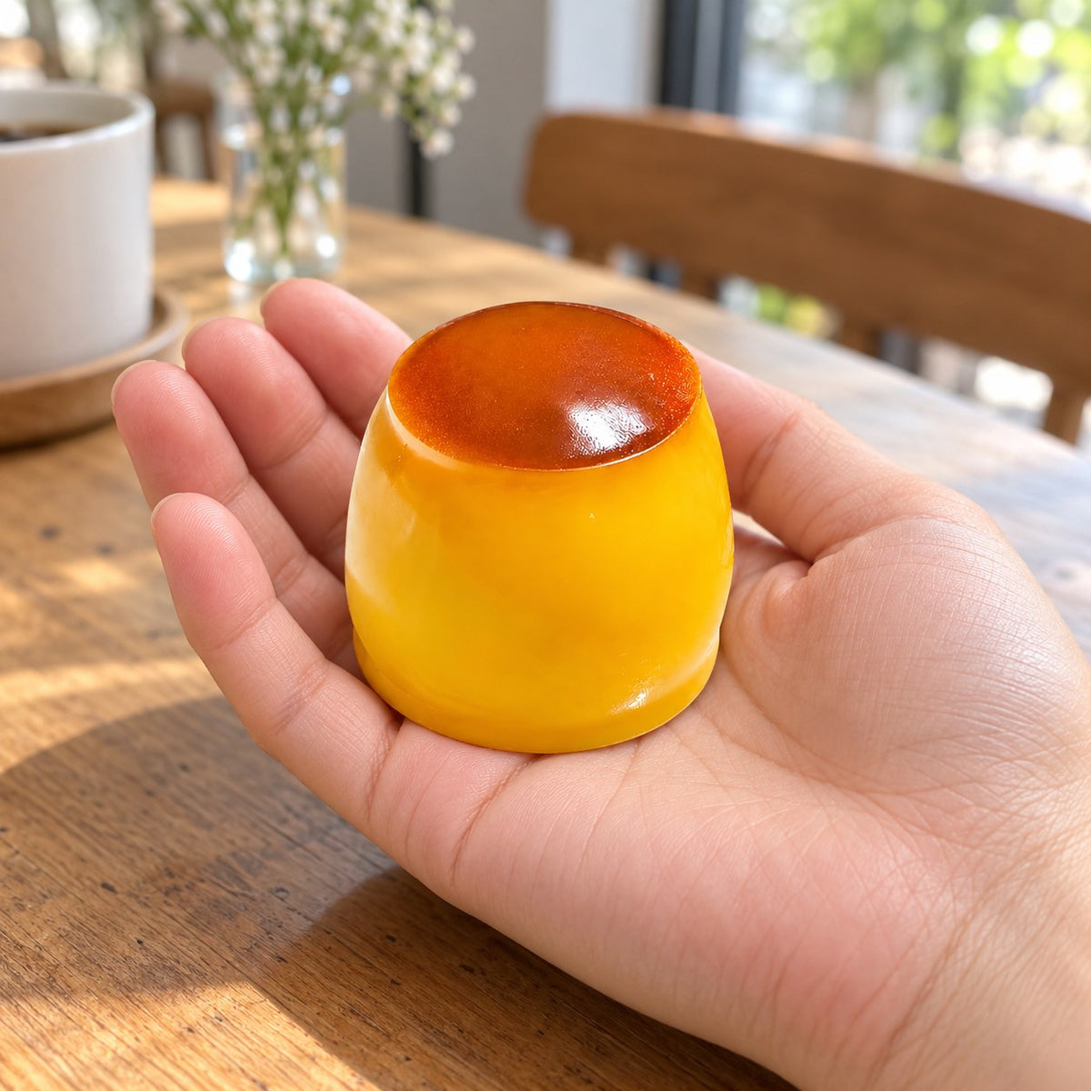 Pudding squishy crunchy, held in a hand to show the real size