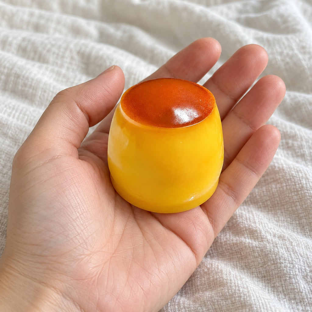 Pudding squishy, held toward the camera, first-person view
