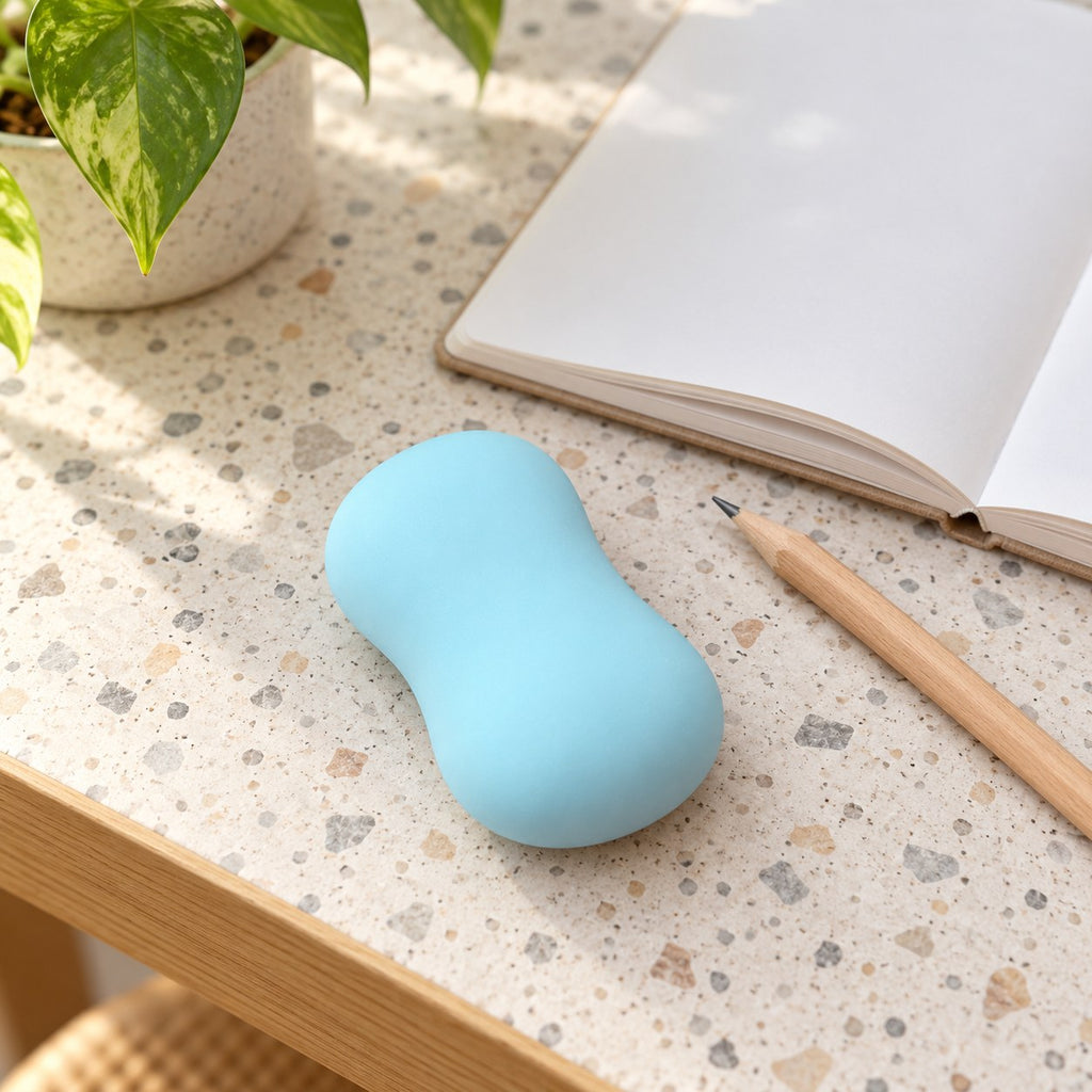Crunchy Soap Squishy, Handmade Ball (Blue), on a desk with a notebook and pencil