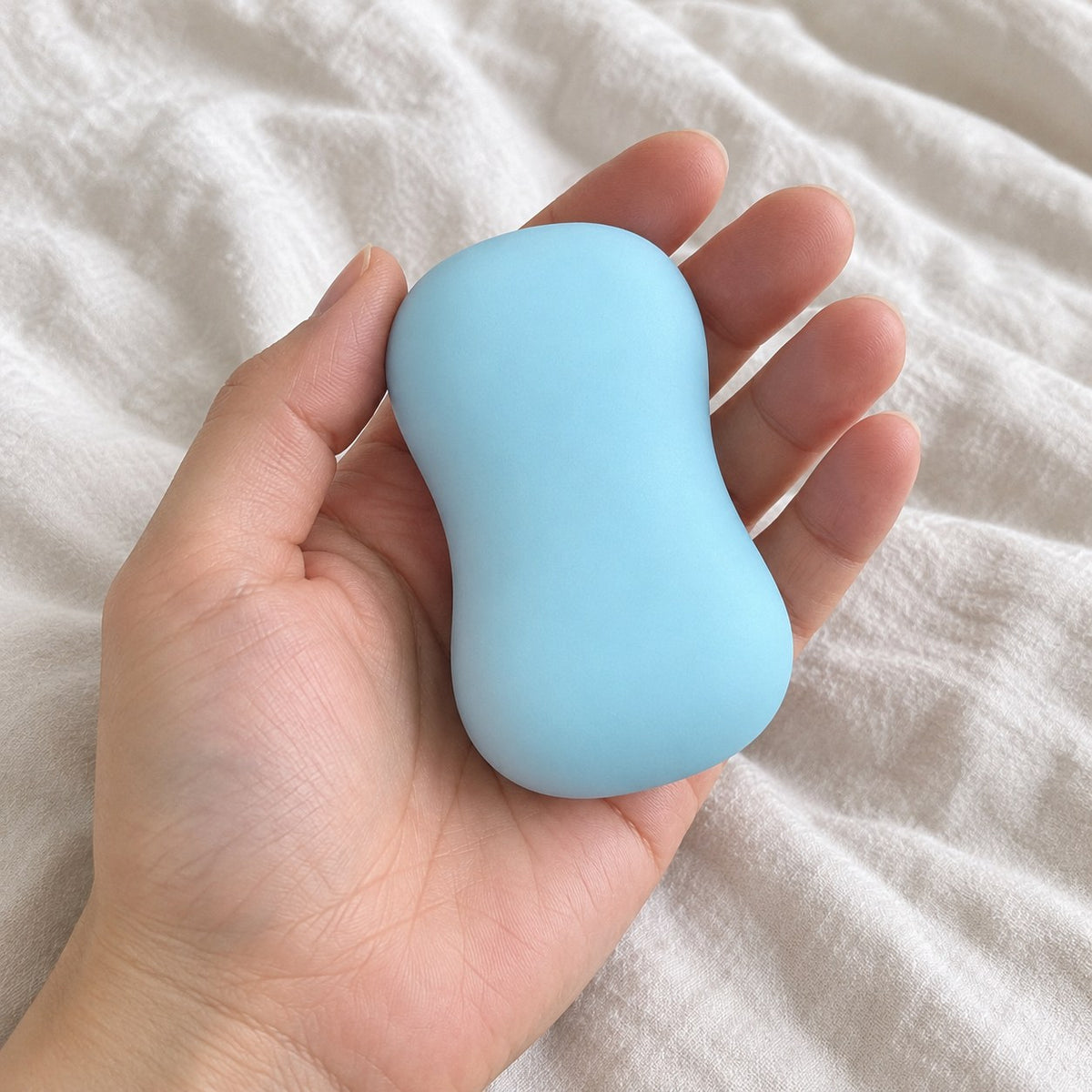 Soap squishy crunchy (Blue), held toward the camera, first-person view