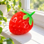 Strawberry squishy taba, on a sunny windowsill