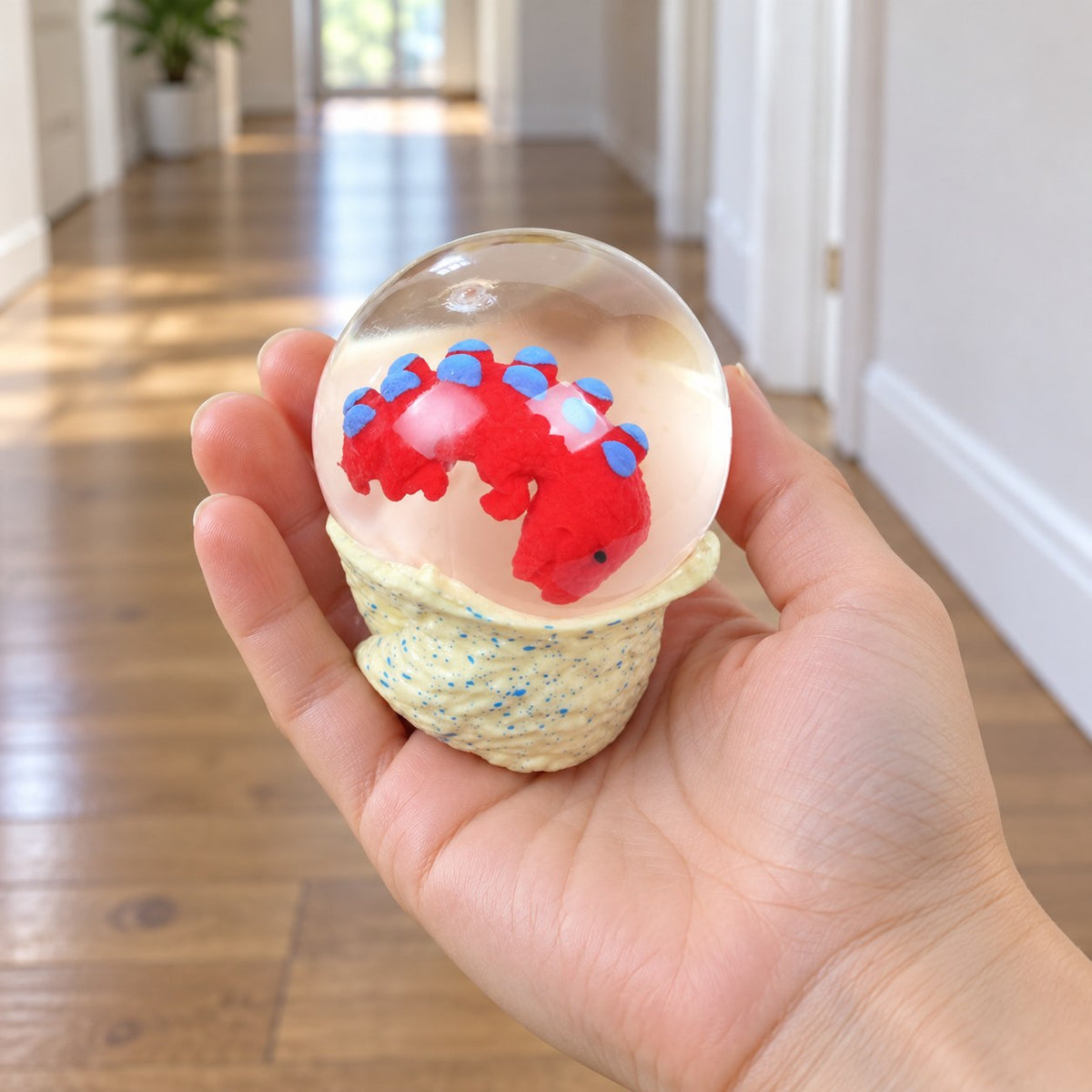 Dinosaur Egg Squishy, Water Ball with Baby Dino, held in a hand to show the real size