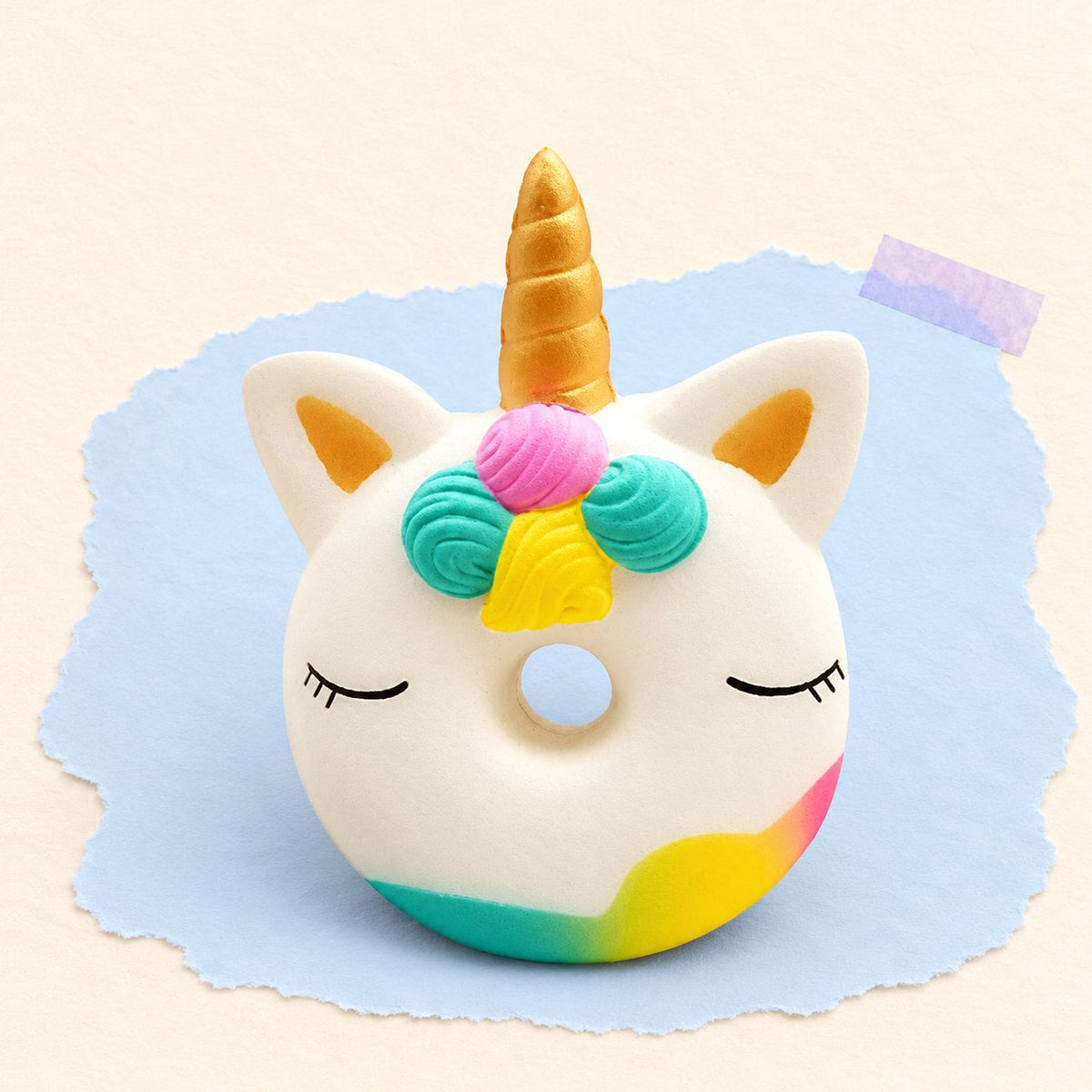 Donut squishy met eenhoorn, slow rising en geurend, op pastelkleurig papier