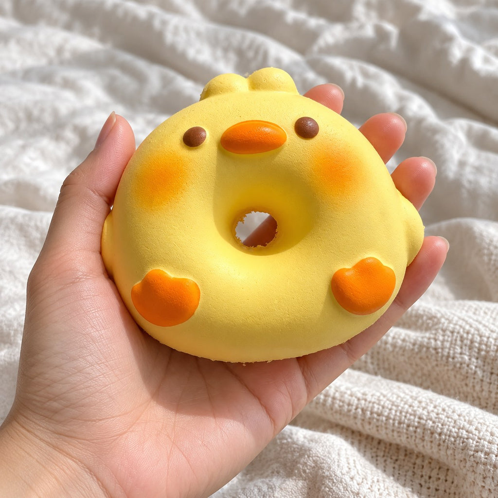 Pig squishy kawaii (Duck), held toward the camera, first-person view