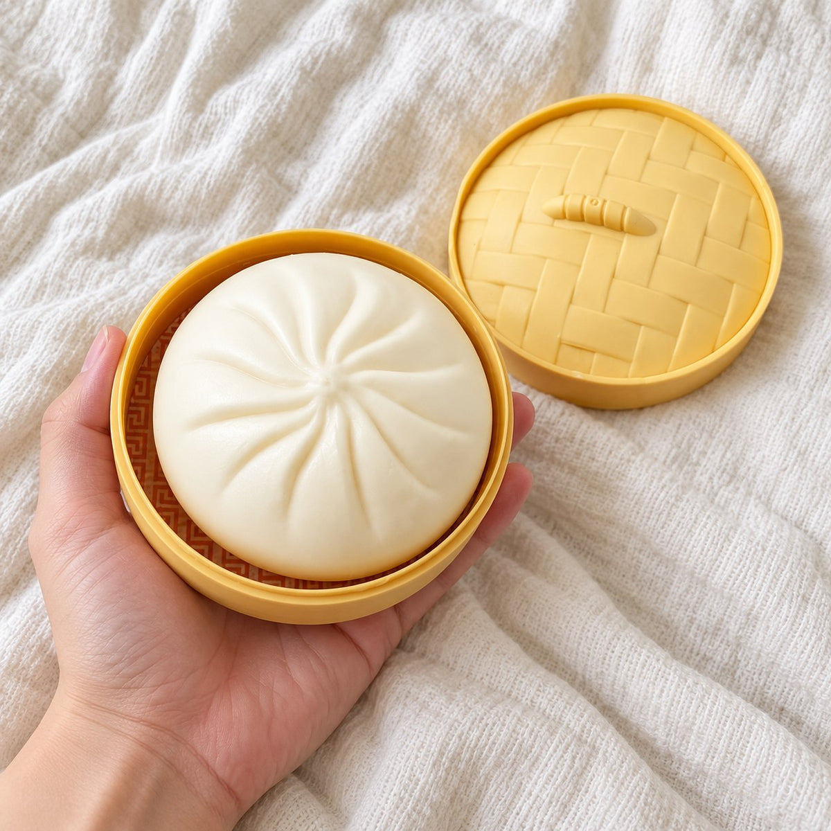 Bao Dumpling Squishy in Steamer Basket, held toward the camera, first-person view