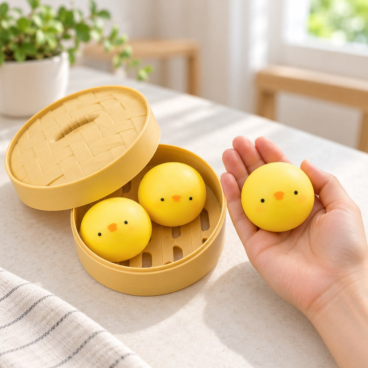 Chick Bao Squishy, 3 Buns in Steamer Basket, held in a hand to show the real size