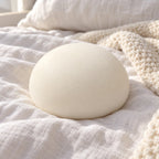 Steamed bun squishy (white), on a cozy bed with soft blankets