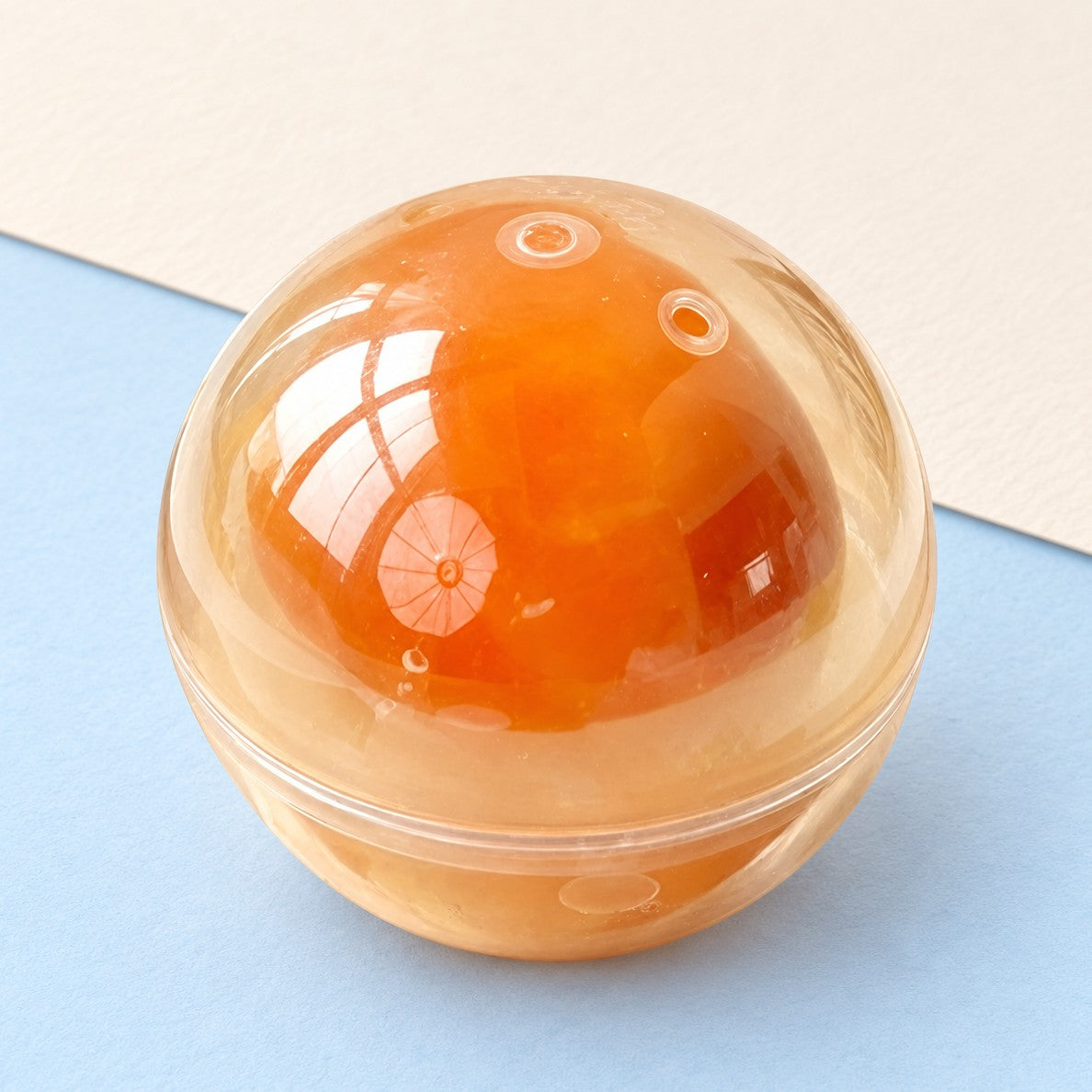 Egg yolk squishy coconut oil – Egg Yolk Coconut Oil Squishy Ball, product photo on pastel paper