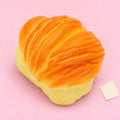 Flaky pastry squishy – Flaky Pastry Squishy, Oval Bun 8.7 cm, product photo on pastel paper