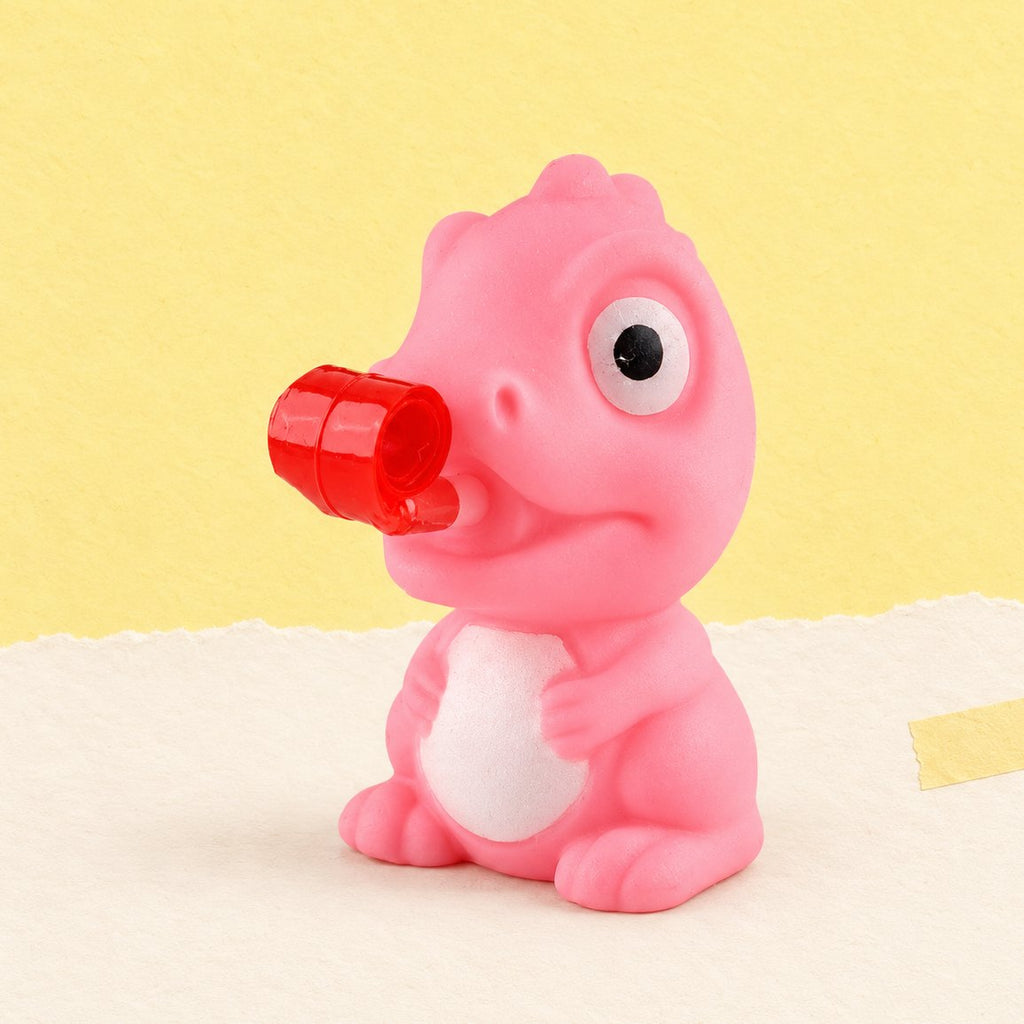 Frosch oder Dino Squishy mit Zunge zum Herausdrücken, hier der Dino in Zufallsfarbe, auf Pastellpapier