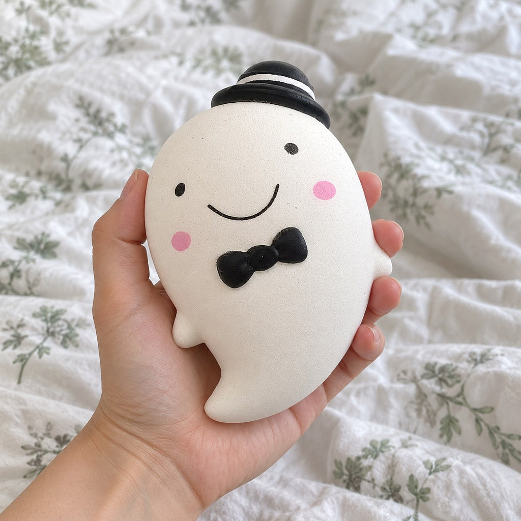 Ghost squishy (white), held toward the camera, first-person view