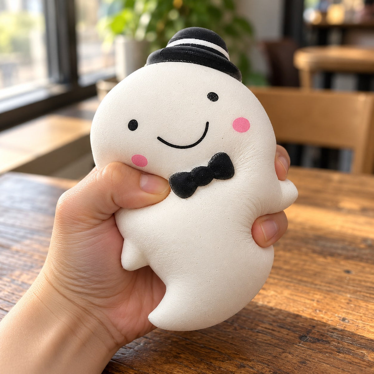 Slow Rising Ghost Squishy, 14.5 cm (white), being squeezed by hand, soft and squishy