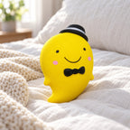 Slow Rising Ghost Squishy, 14.5 cm (yellow), on a cozy bed with soft blankets