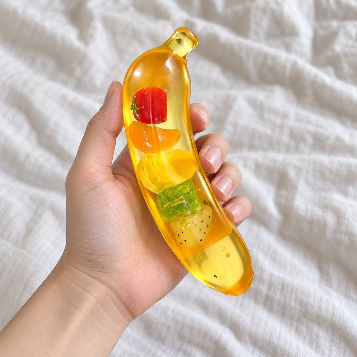Giant banana squishy, held toward the camera, first-person view