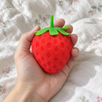 Giant strawberry squishy, held toward the camera, first-person view