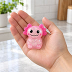 Glitter Axolotl Squishy, Slow Rising (pink), held in a hand to show the real size