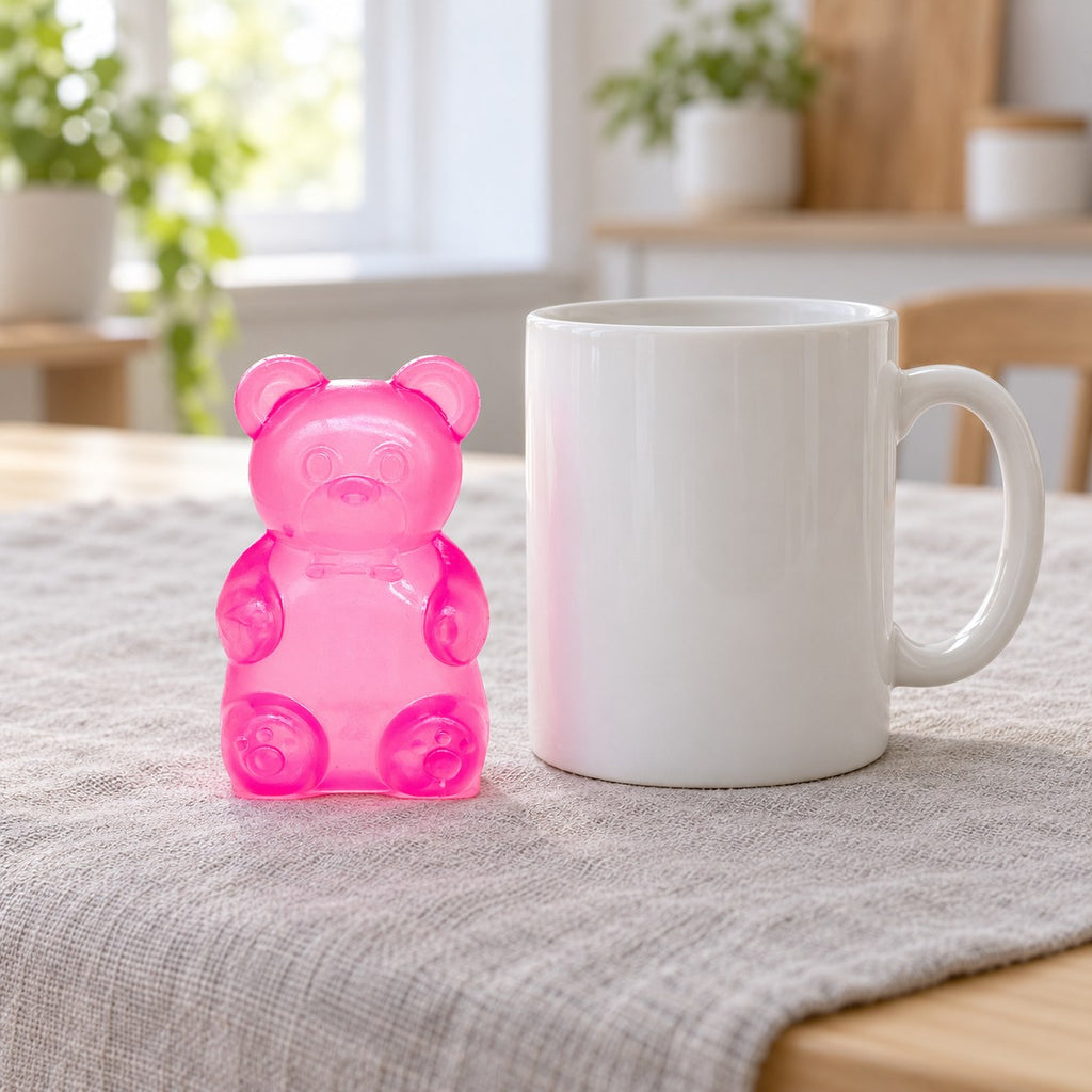 Gummy Bear Squishy, Slow Rising (pink), next to a coffee mug for size comparison