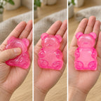 Gummy bear squishy (pink), squished flat, half risen and fully back in shape