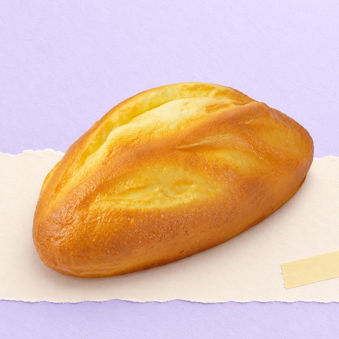Haverbrood squishy, rustiek brood van 18 cm op pastelkleurig papier