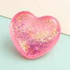 Heart squishy glitter – Glitter Heart Squishy, Maltose Style 6.7 cm (Pink), product photo on pastel paper