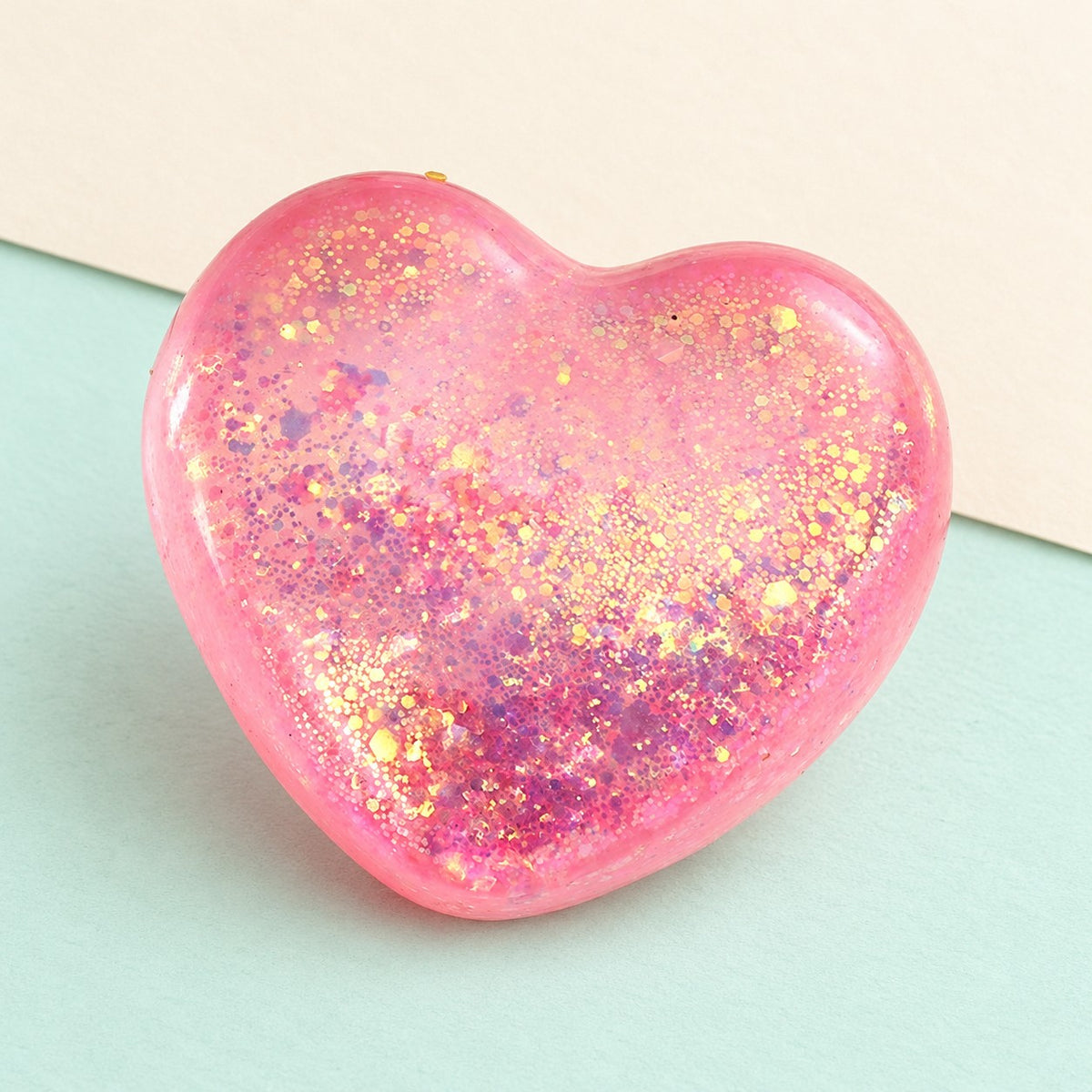 Heart squishy glitter – Glitter Heart Squishy, Maltose Style 6.7 cm (Pink), product photo on pastel paper