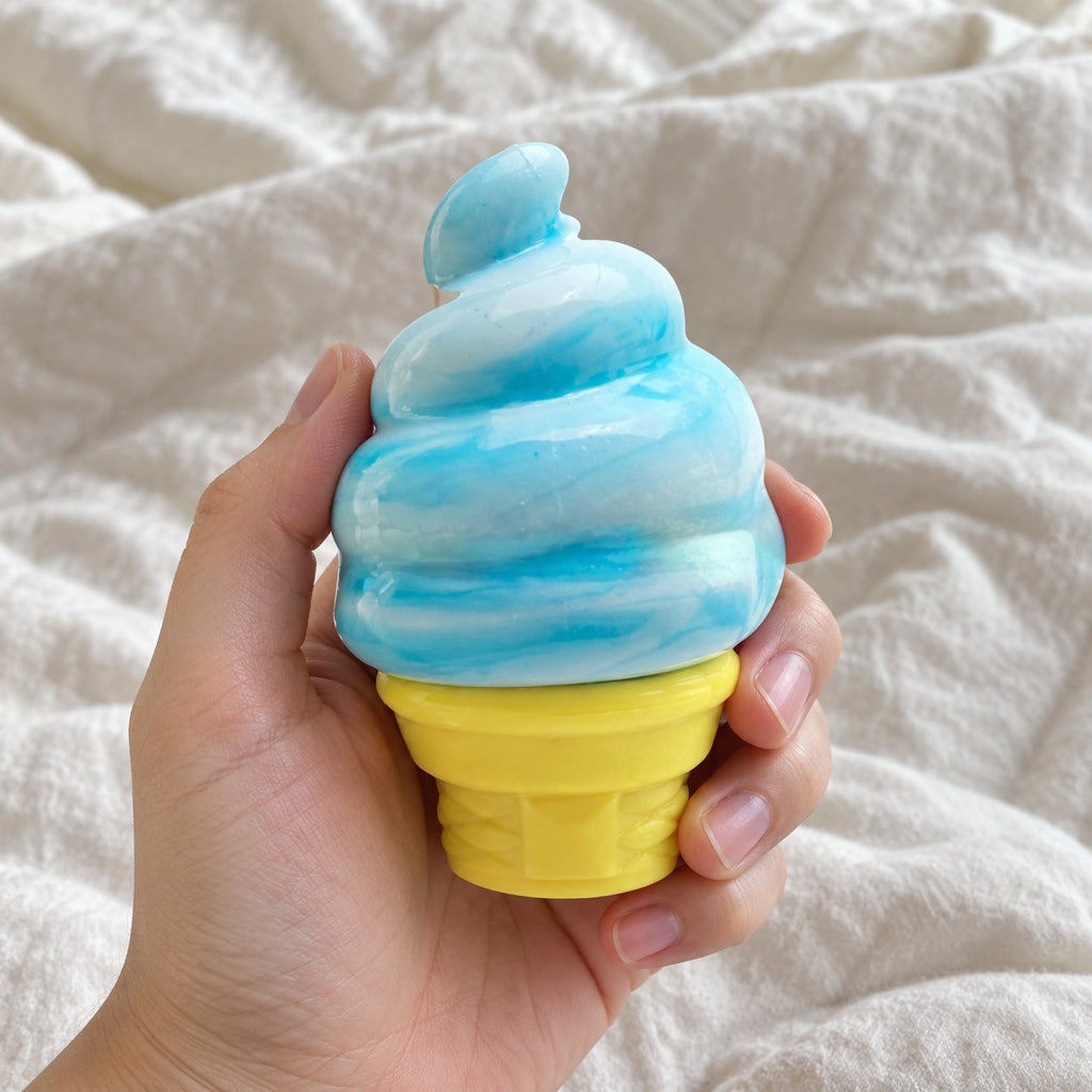 Ice cream squishy (blue), held toward the camera, first-person view
