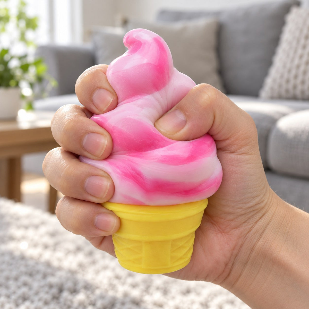 Ice Cream Cone Squishy, Stretchy Silicone (pink), being squeezed by hand, soft and squishy