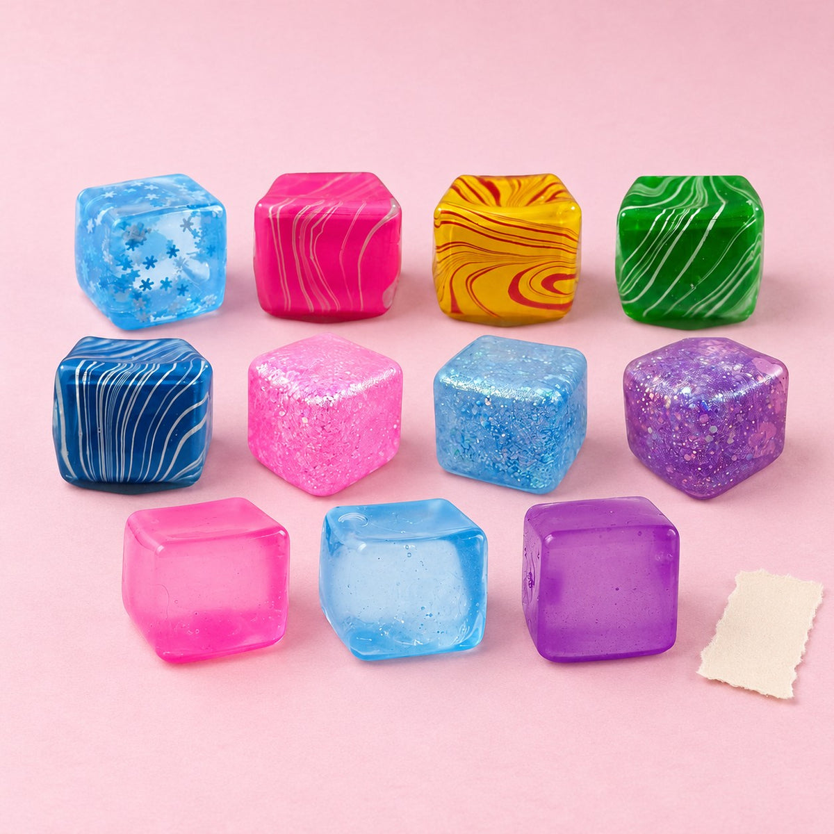 Ice cube squishy set jelly – Ice Cube Squishy Collection, all 11 designs, product photo on pastel paper
