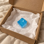 Ice cube squishy mini (blue), unboxed from a parcel with tissue paper