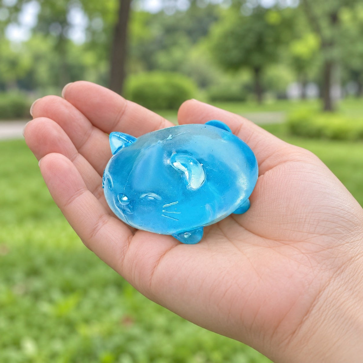 Jelly Cat Squishy, Clear Maltose (blue), held in a hand to show the real size