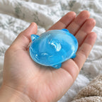 Jelly cat squishy (blue), held toward the camera, first-person view