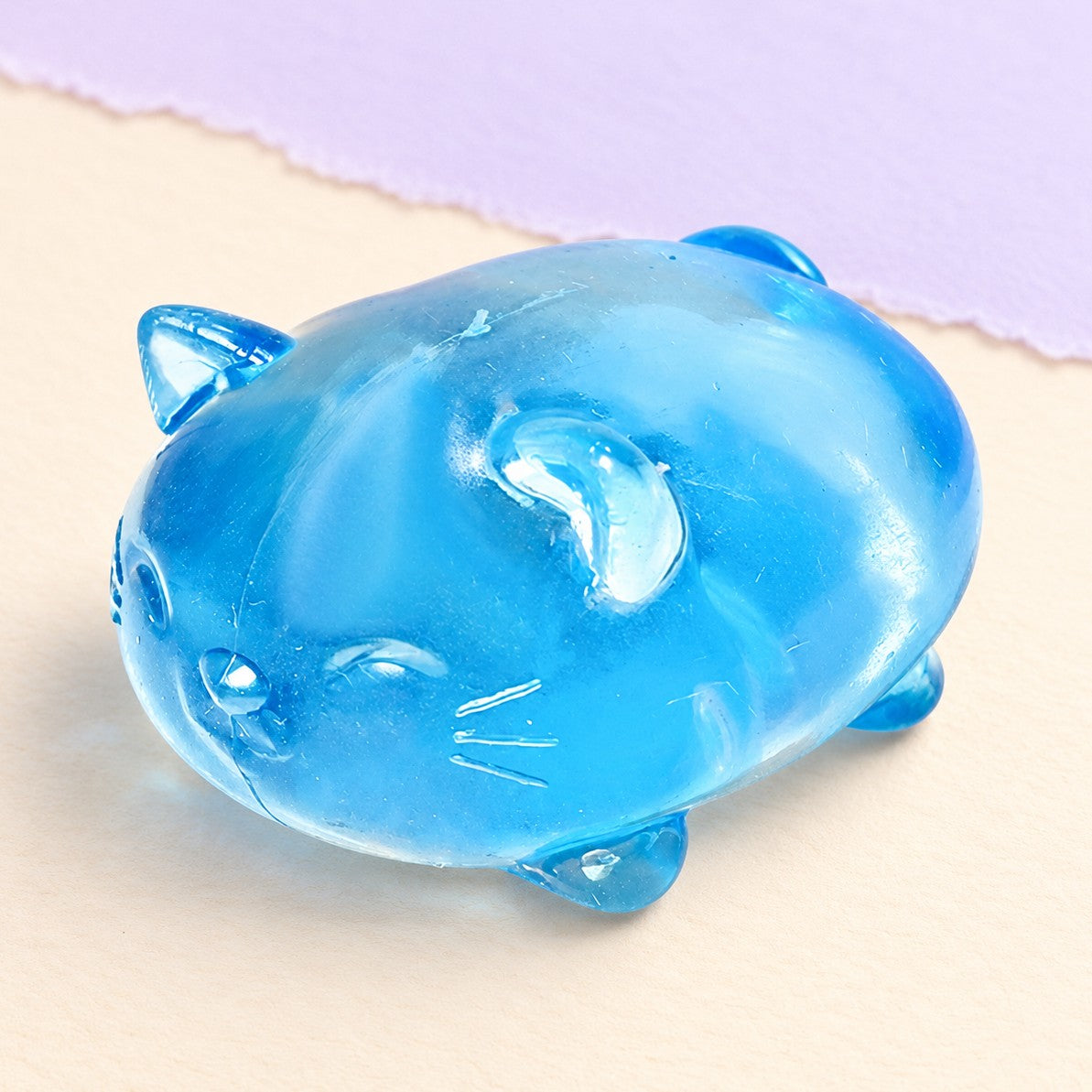 Jelly cat squishy maltose – Jelly Cat Squishy, Clear Maltose (Blue), product photo on pastel paper