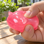 Jelly Cat Squishy, Clear Maltose (pink), being squeezed by hand, soft and squishy