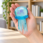 Jellyfish Squishy with Glitter, Soft TPR (blue), held in a hand to show the real size