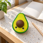 Jumbo Avocado Squishy, Kawaii, on a desk with a notebook and pencil