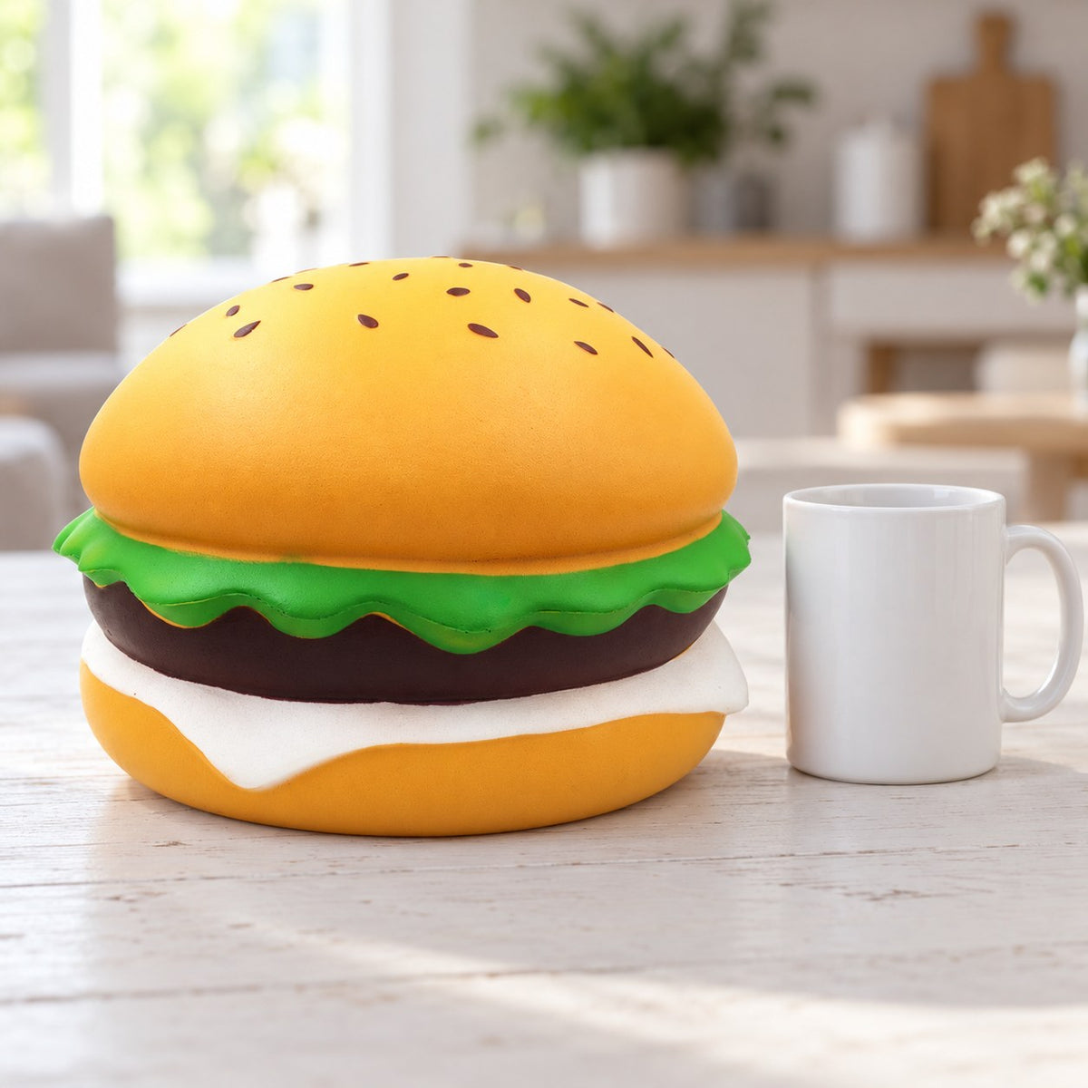 Jumbo burger squishy giant sesame burger 24 cm, next to a coffee mug for size comparison